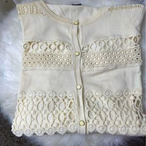 A see throughCream colored sweater in a Size L